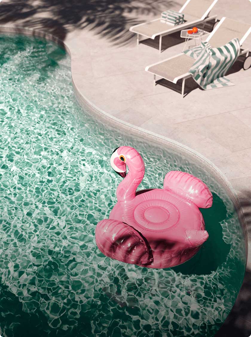 Custom backyard pool featuring a pink flamingo floatie.