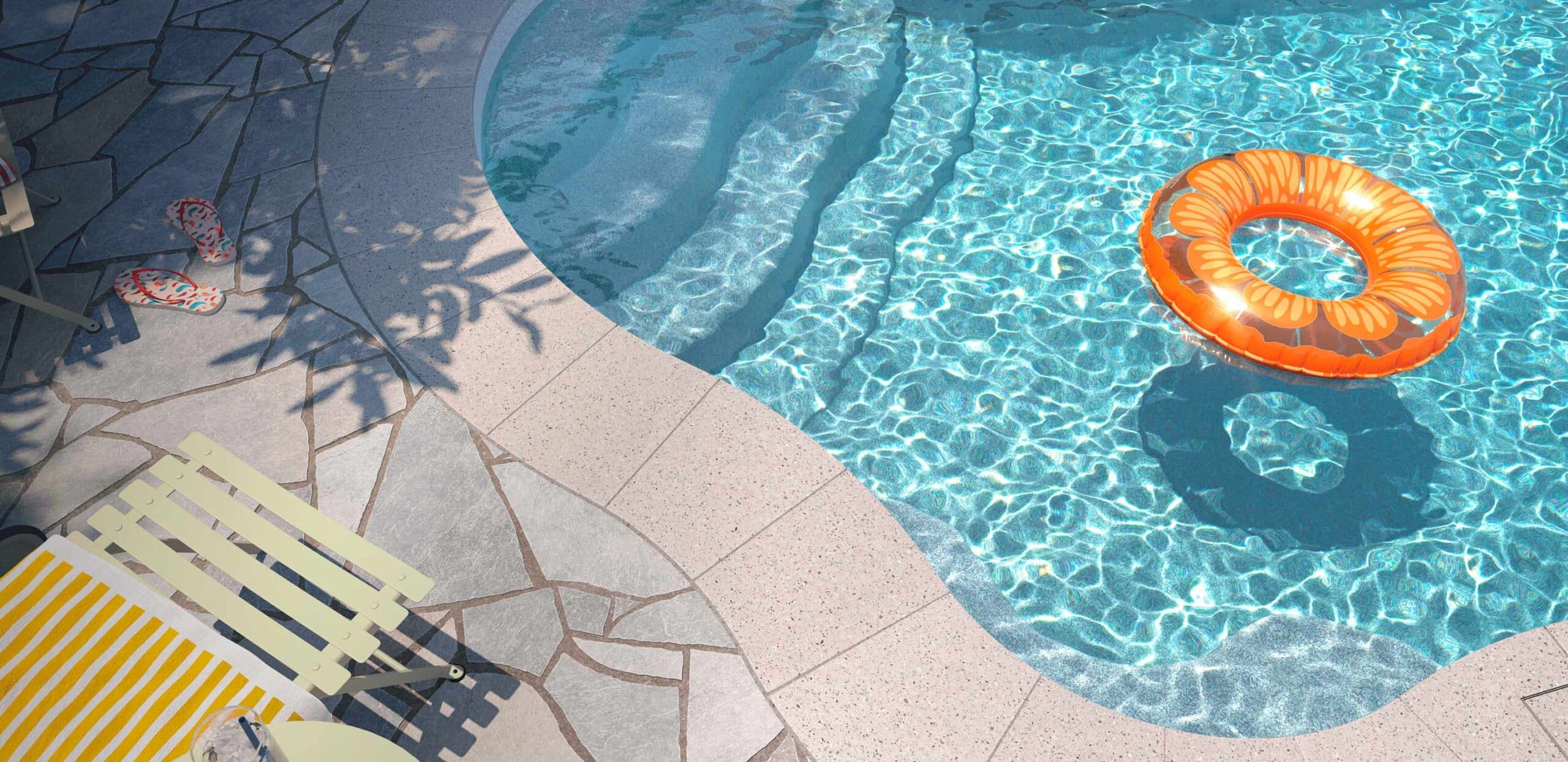 Curved fiberglass pool with an orange float, surrounded by patio furniture and landscaping.
