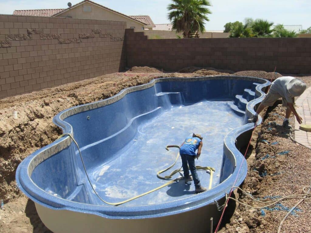 Latham builders installing fiberglass inground pool