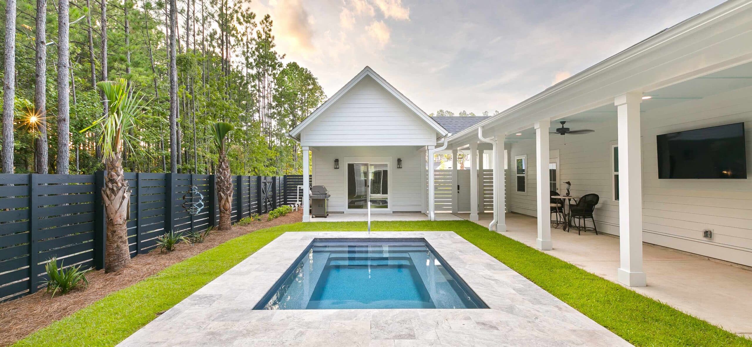 Cozy fenced in backyard with pool house and small plunge pool