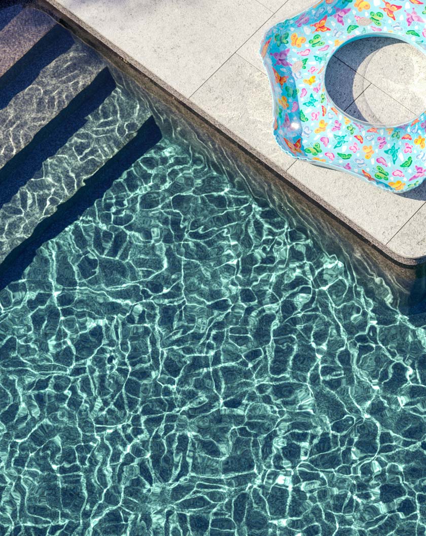 top view of pool looking down at water and pool float