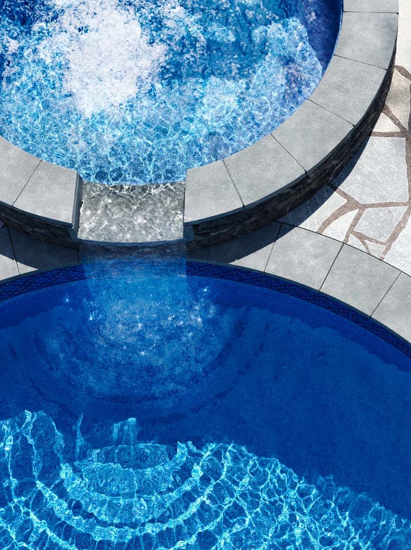 overhead view of fiberglass inground pool and hot tub with blue color