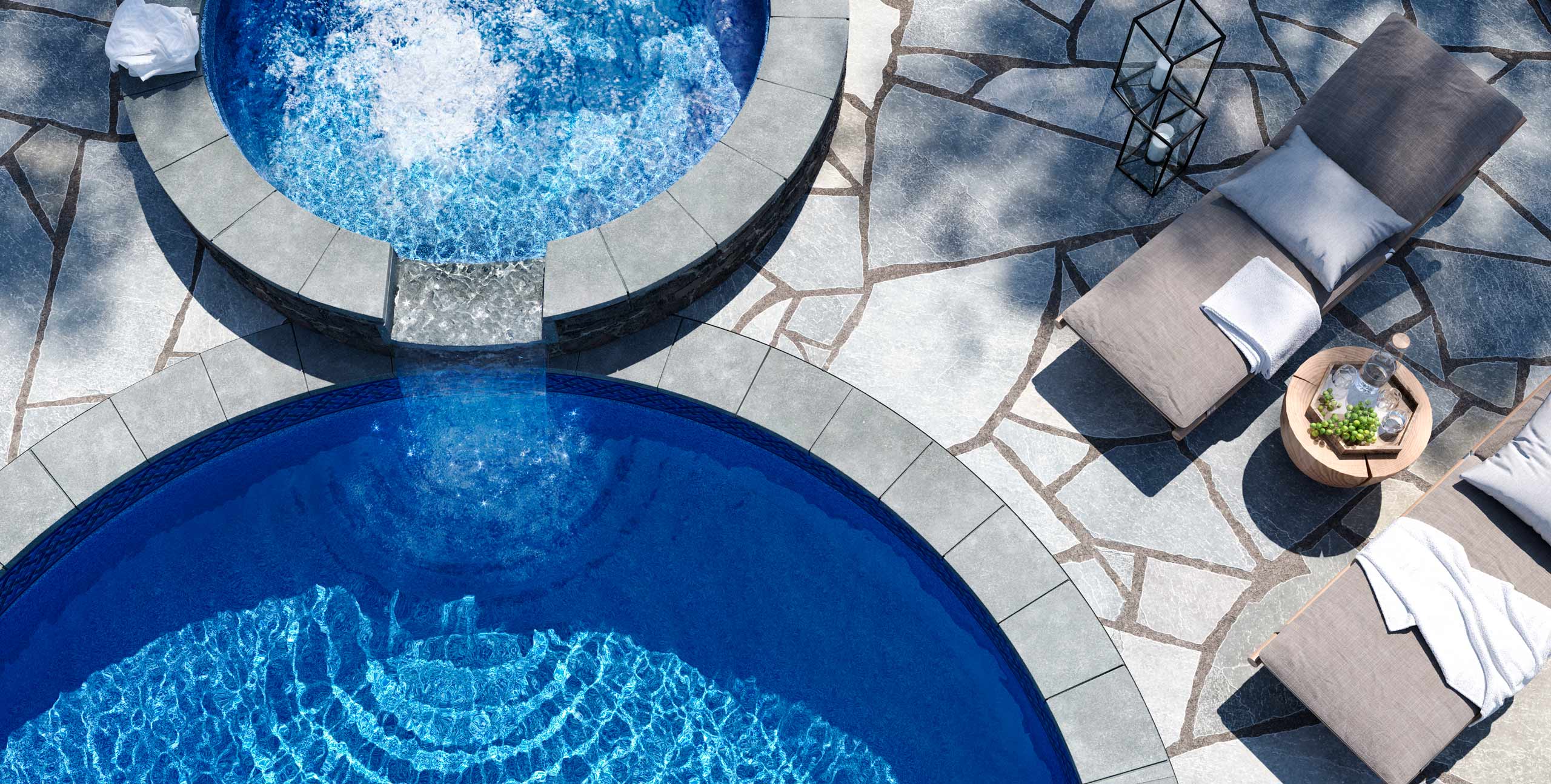 Tranquil overhead image of luxory pool and spa with lounge chairs