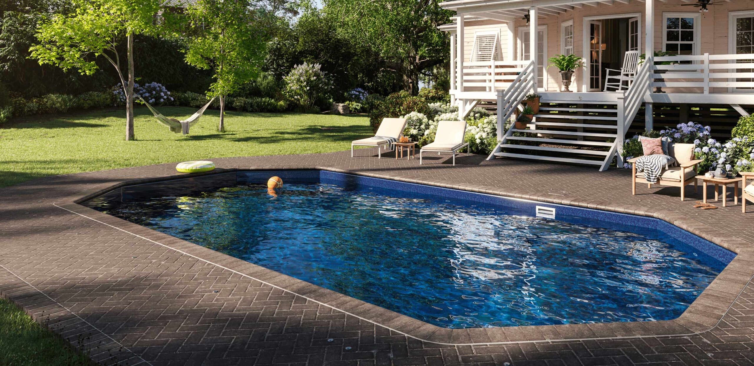 inground pool with paver decking in picturesque New England yard