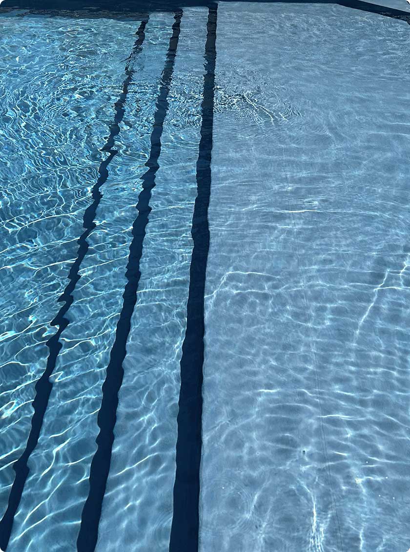 Vinyl liner pool with molded wide steps leading into shallow end.