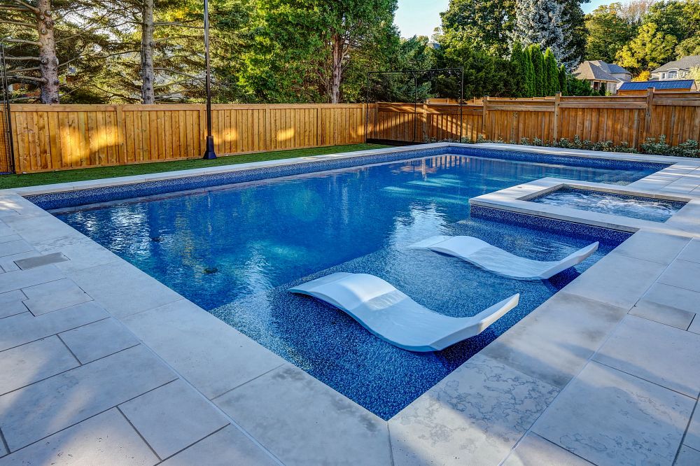Sunny backyard with a medium blue vinyl liner pool.