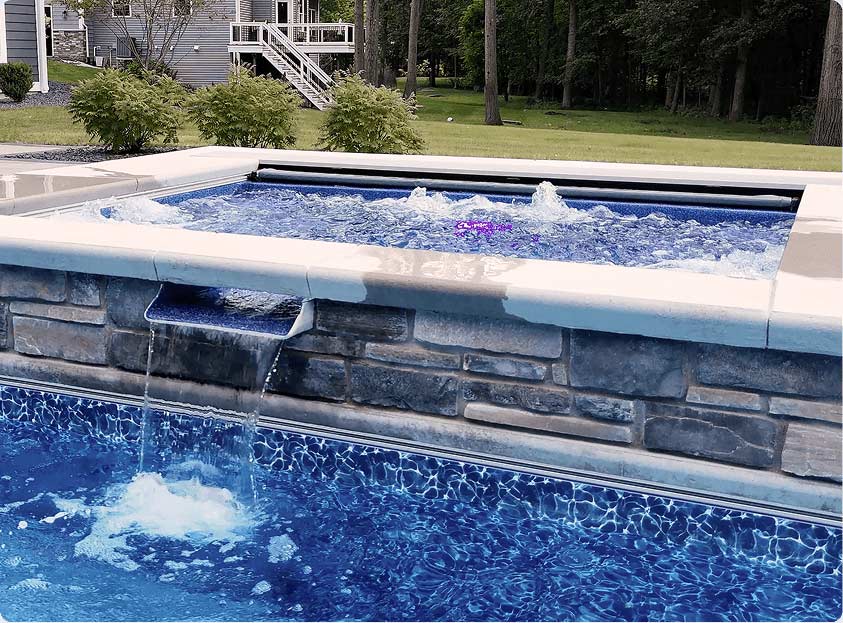 raised spillover spa bubbling in backyard