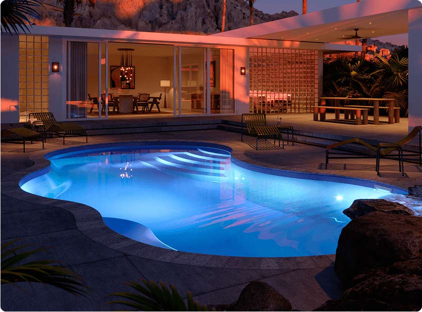 inground pool with spa at night with led lighting