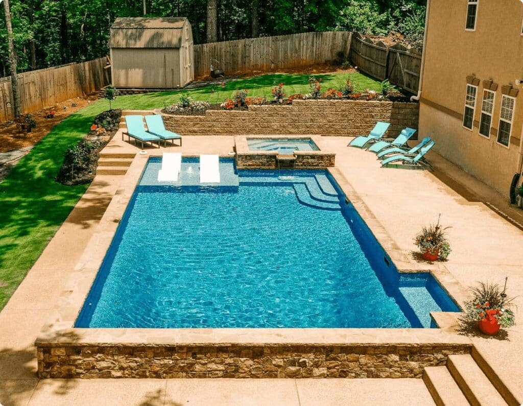 large backyard with vinyl liner inground pool with built in tanning ledge