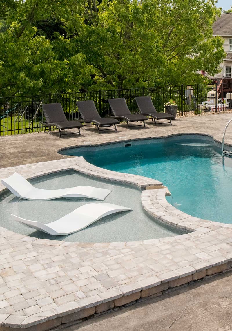 Tanning ledge in a pool under sunny skies.