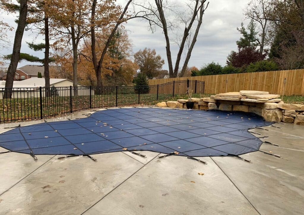 winter pool cover installed to protect pool with curved edges