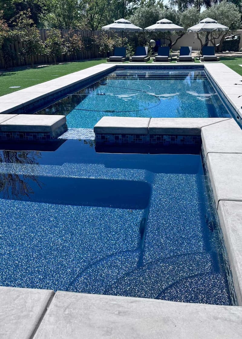 Overview of spa overflowing into inground pool