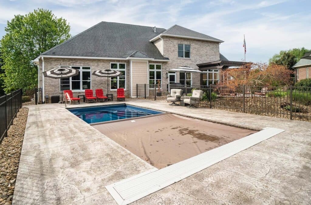 automatic safety cover closing over pool to protect water